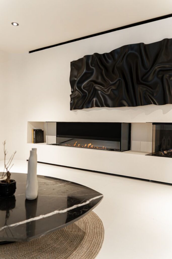 Contemporary living room featuring a minimalist fireplace and chic decor elements.